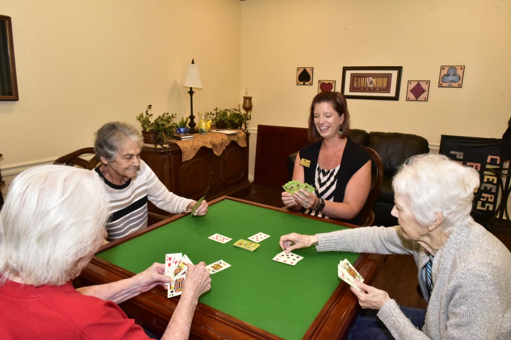 Residents and a staff member playing poker at Garden Place Columbia in Columbia, Illinois. 