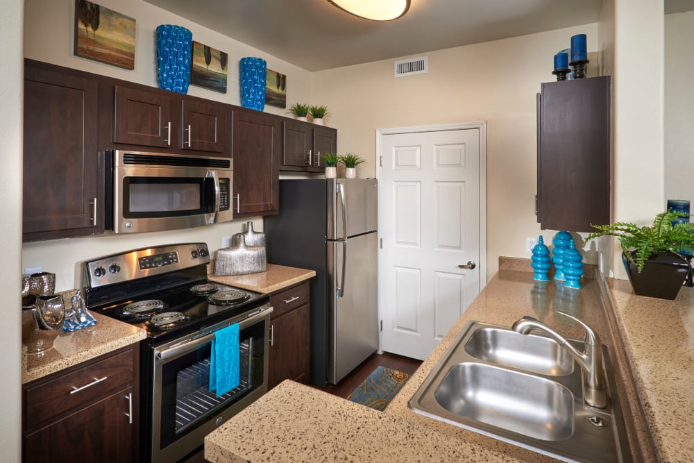 A kitchen with plenty of cabinet space at Promenade at Hunter's Glen Apartments in Thornton, Colorado