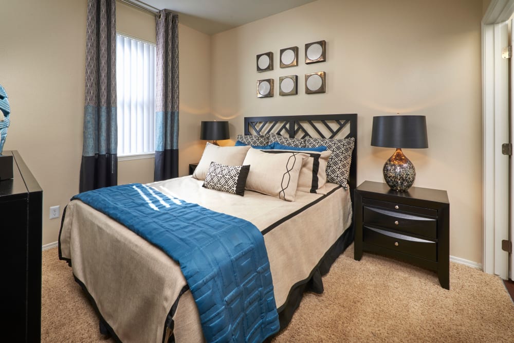 Master bedroom with a window for natural lighting at Promenade at Hunter's Glen Apartments in Thornton, Colorado