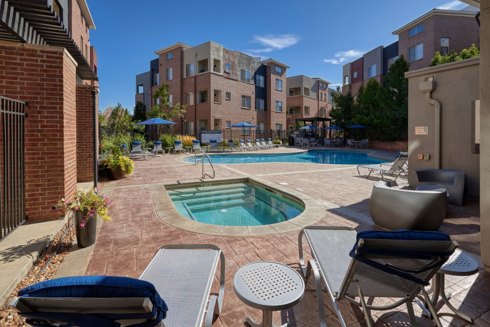 Swimming pool and spa with a sundeck and lounge chairs at The Rail at Inverness in Englewood, Colorado