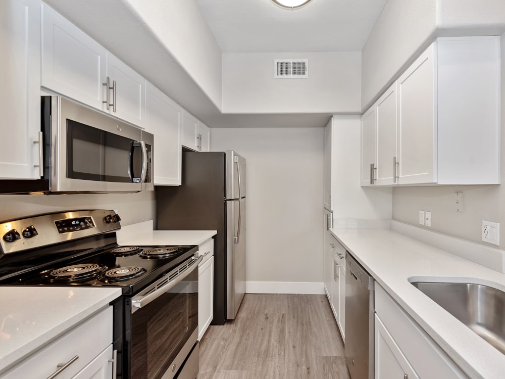 Kitchen with modern appliances and plenty of cabinets at The Retreat Apartments in Phoenix, AZ