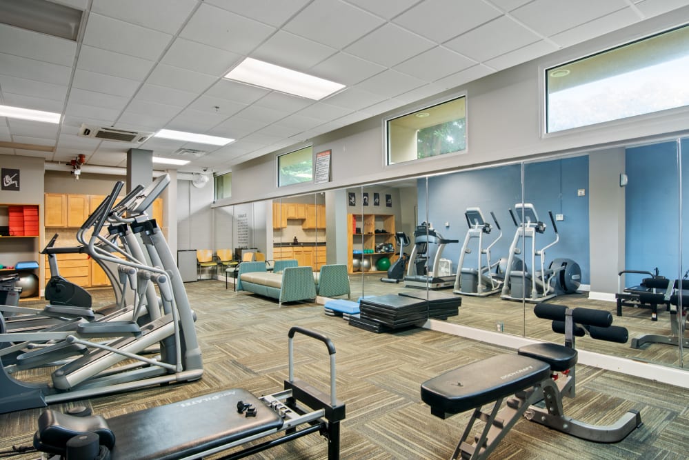 A fitness center with individual workout stations at Goldelm at 414 Flats in Knoxville, Tennessee