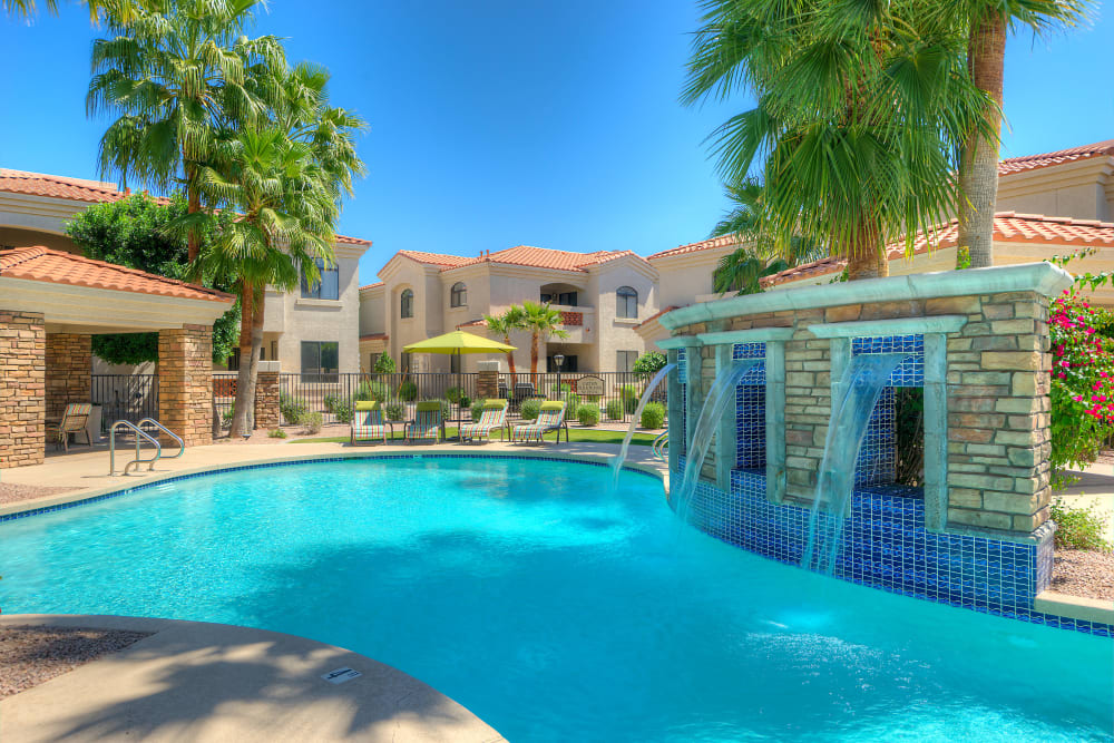 Gorgeous resort-style swimming pool with a water feature at San Prado in Glendale, Arizona