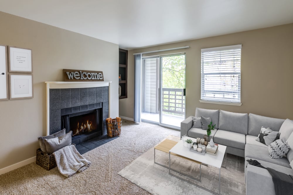 A living room complete with a fireplace at Olin Fields Apartments in Everett, Washington