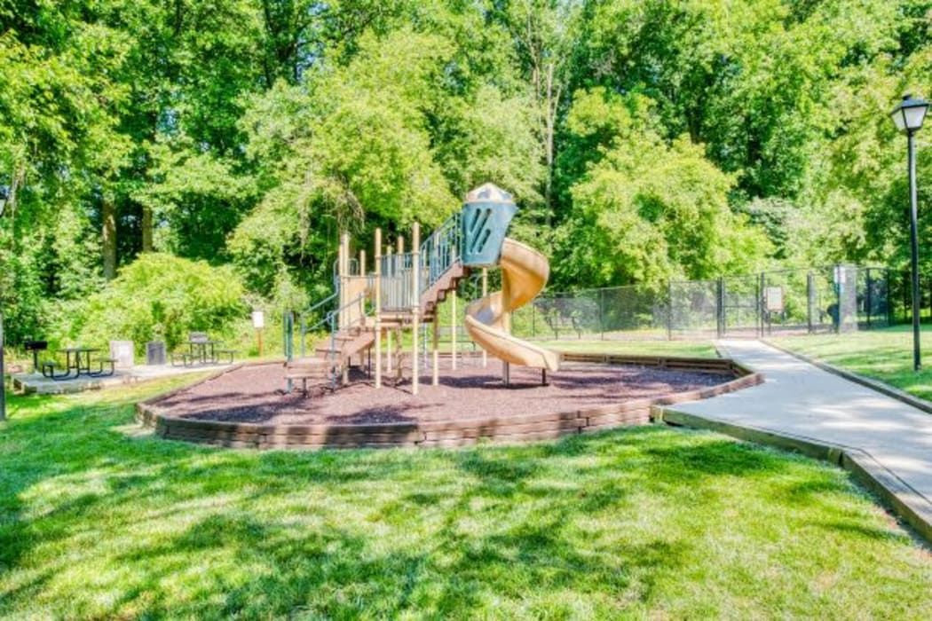 Resident couple going for a walk piggy-back style at our tree-lined community at The Timbers at Long Reach Apartments in Columbia, Maryland