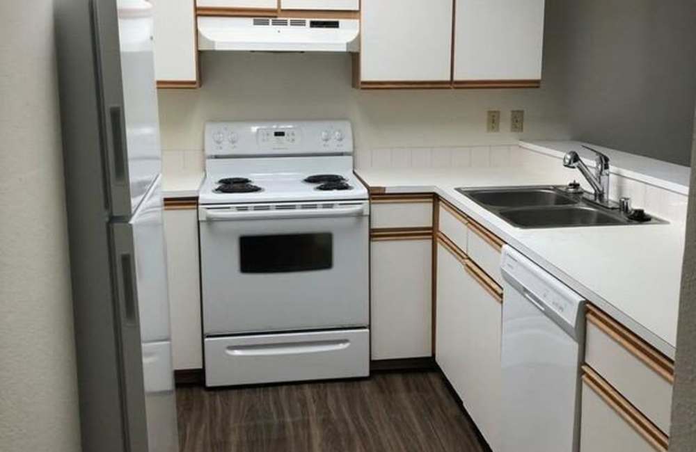Kitchen with white appliances at Cambridge Apartments