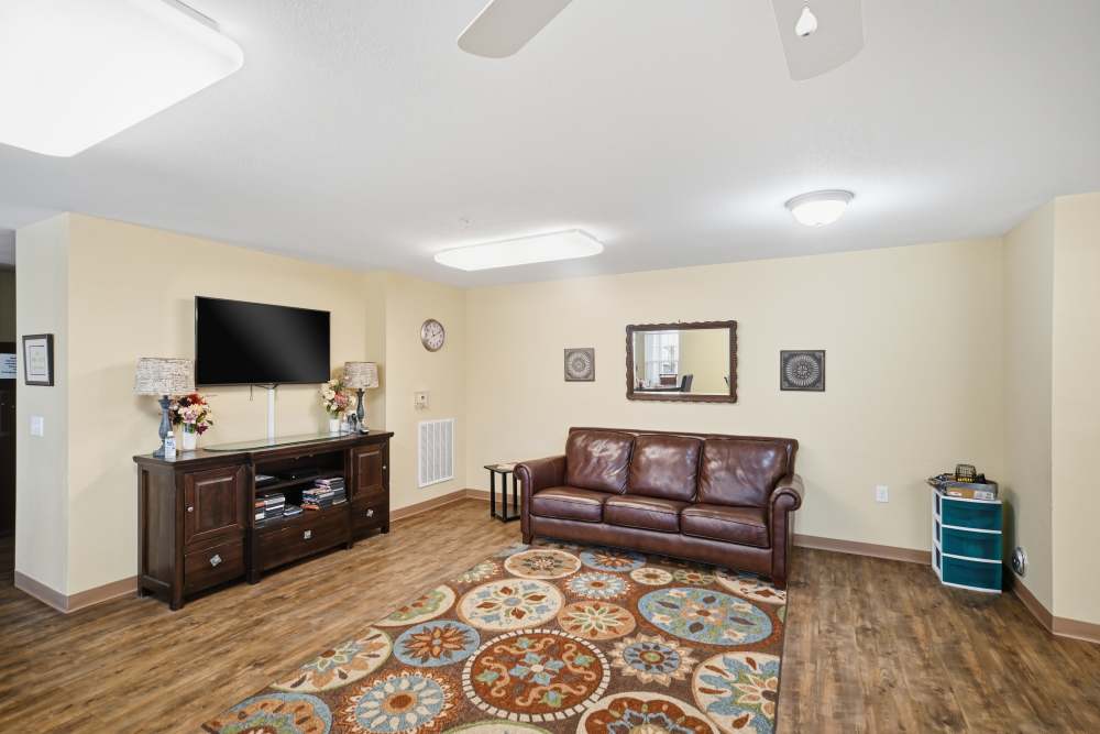 Spacious living room with wood flooring at River Towne Manor in Roanoke Rapids. NC