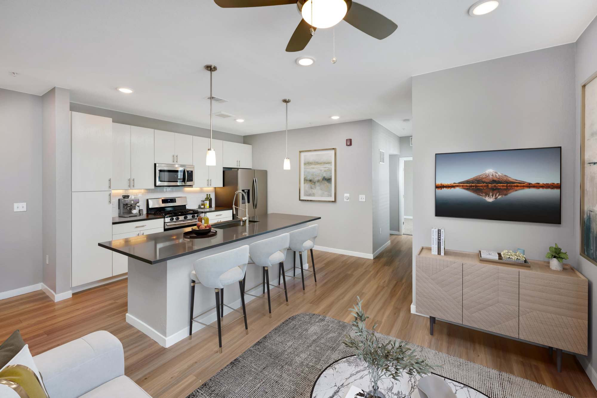 Living room and kitchen with island at Hawthorne Hill Apartments in Thornton, Colorado