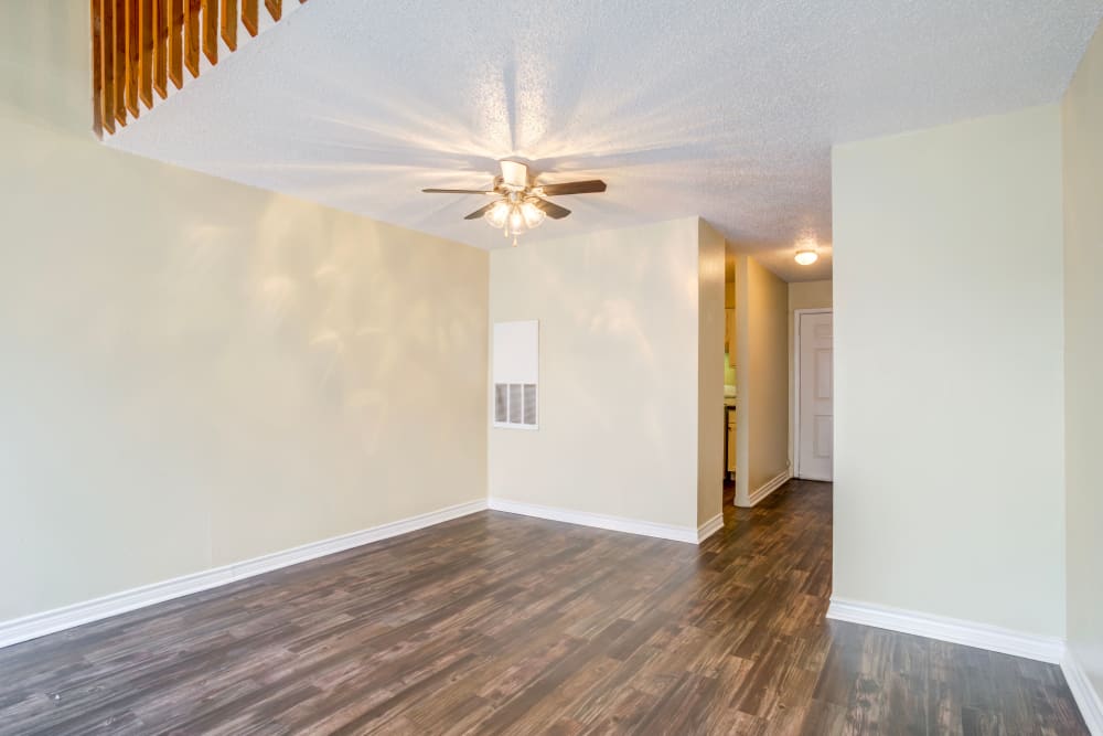 Spacious living room of an apartment with hardwood style flooring at Riverstone Apartments in Bryan, Texas