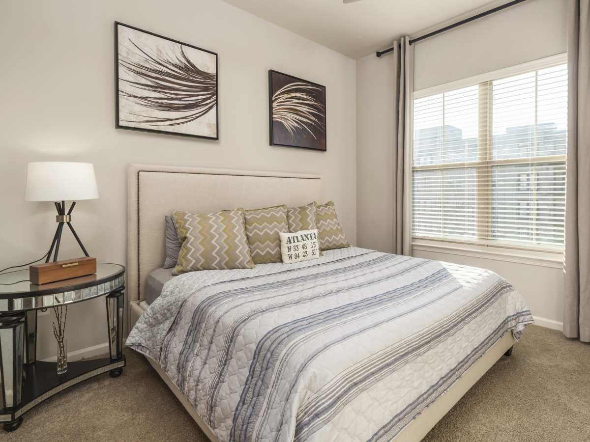 Modern bed with decorative pillows and wall art at Ardmore & Twenty Eighth in Atlanta, Georgia