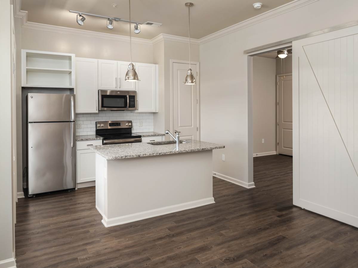 Luxury kitchen island with granite countertop and appliances at Ardmore & Twenty Eighth in Atlanta, Georgia