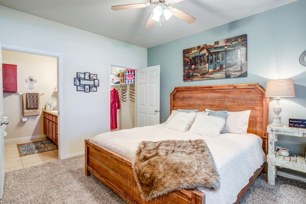 Model bedroom with attached bathroom at Park Hudson Place in Bryan, Texas