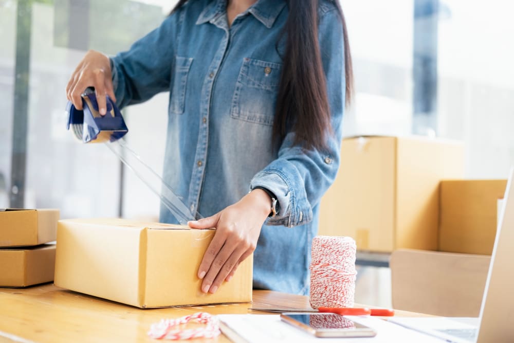 A woman packing boxes to store at Storage Star Folsom in Folsom, California