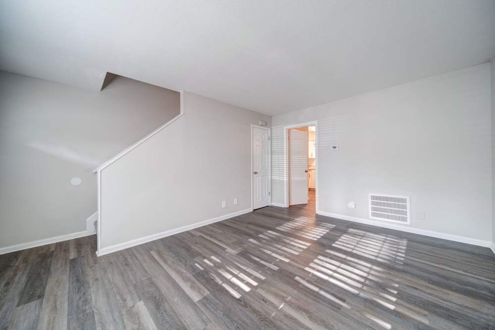 Modern unfurnished living room with staircase at The Manor Townhomes in Winston-Salem, North Carolina