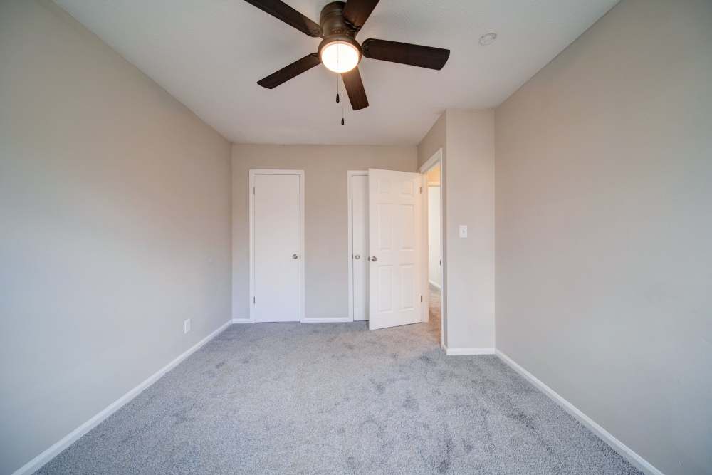 Unfurnished bedroom with ceiling fan at The Manor Townhomes in Winston-Salem, North Carolina