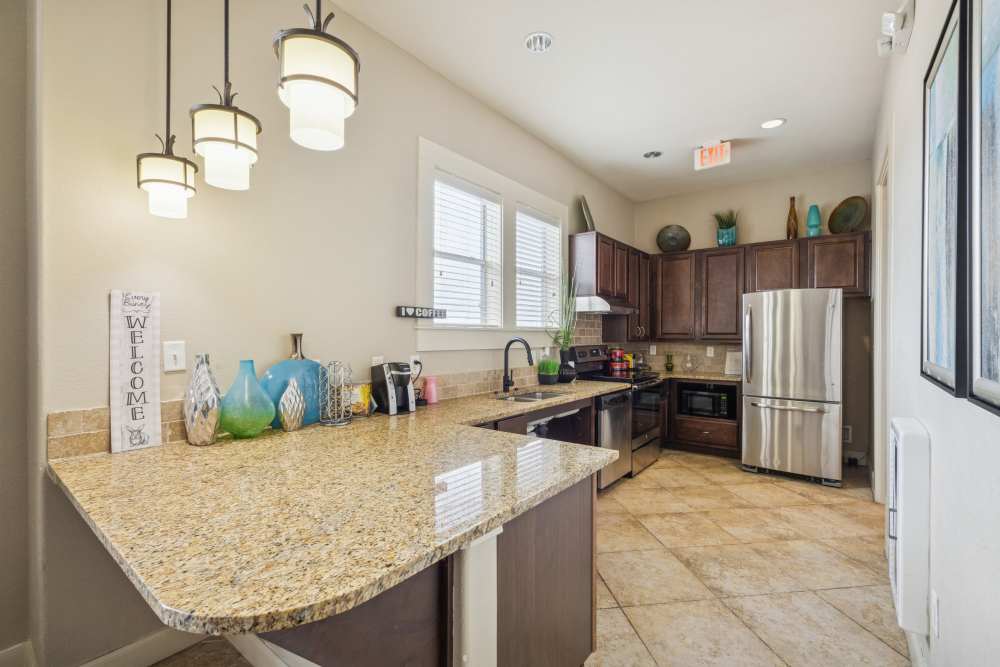Bright kitchen with fully equipped with steel appliances at The Cove at Palmer Point in Texas City, Texas