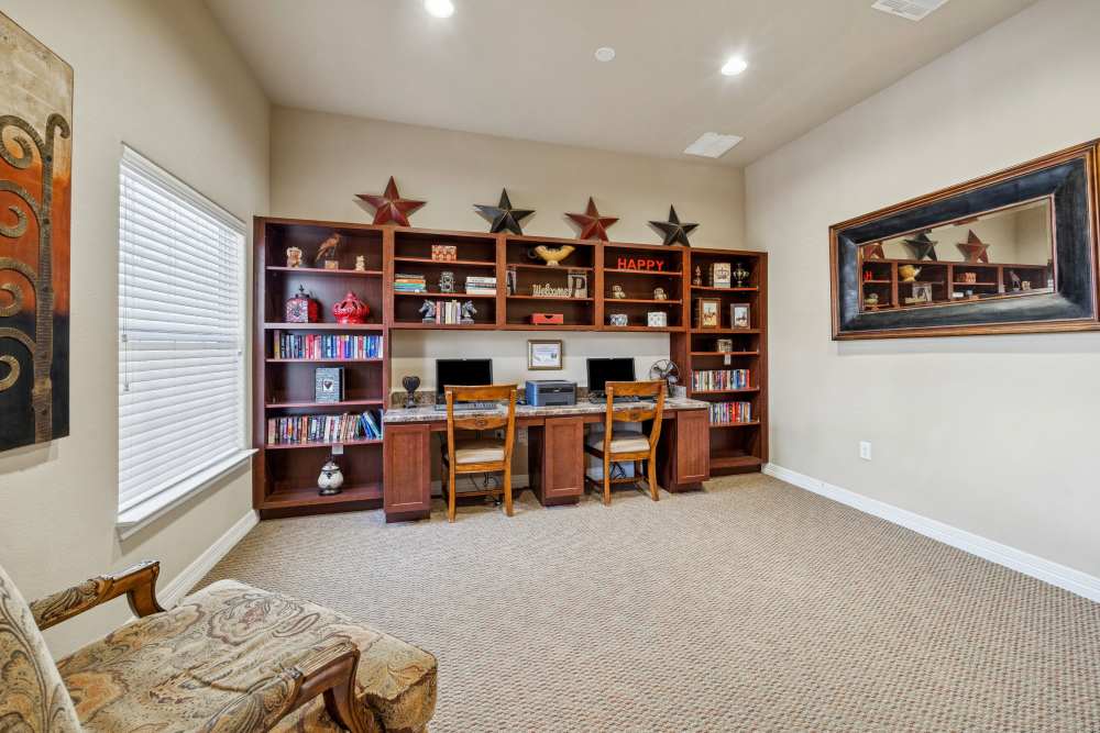 Charming office space with stylish built-in shelves and cozy seating at Arbor Pines in Orange, Texas.