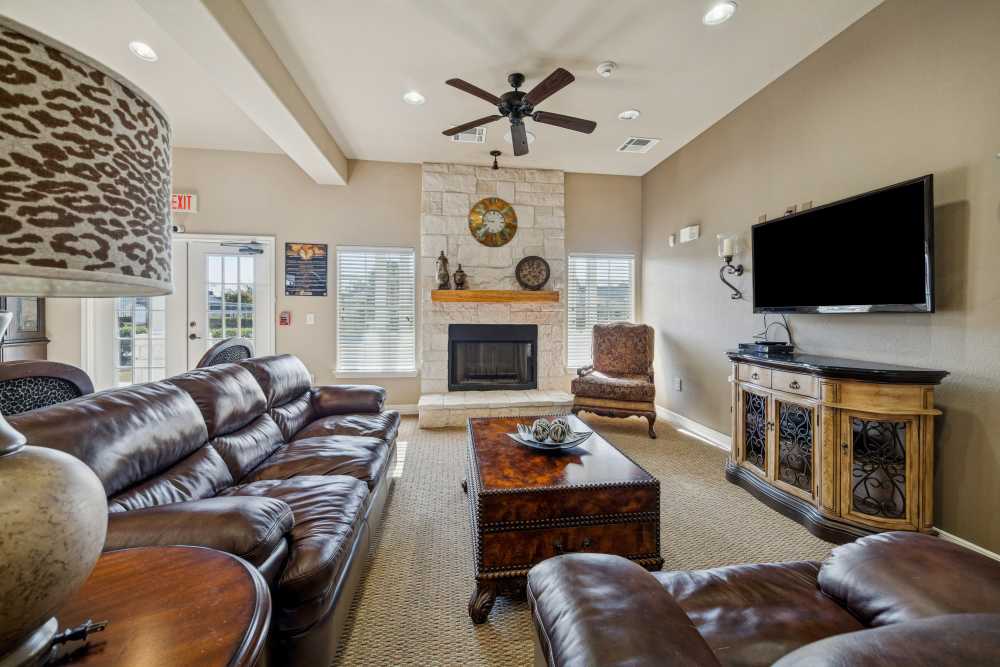 Charming living room featuring a cozy fireplace and elegant furnishings at Arbor Pines in Orange, Texas.