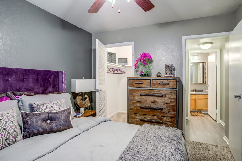 Model bedroom with ceiling fan at EnVue Apartments in Bryan, Texas