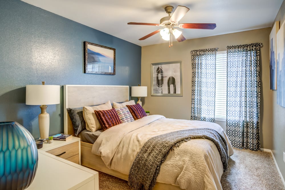 Model bedroom with ceiling fan at EnVue Apartments in Bryan, Texas