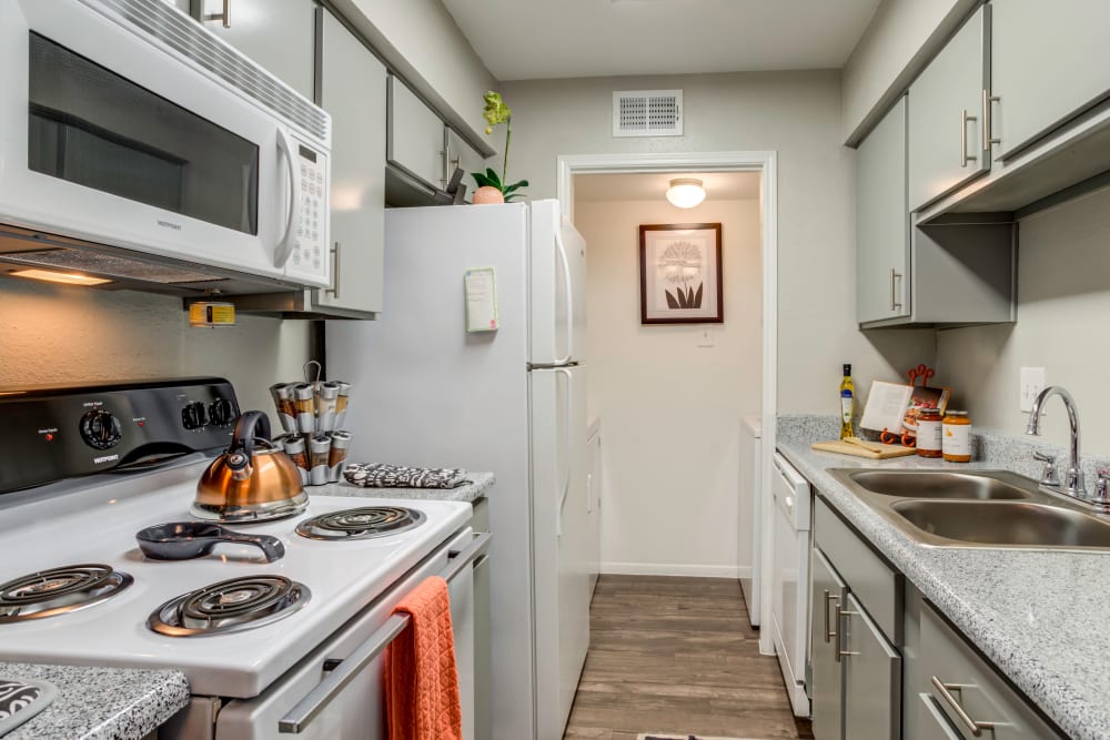 Kitchen with granite countertops at The Reserve at City Center North in Houston, Texas
