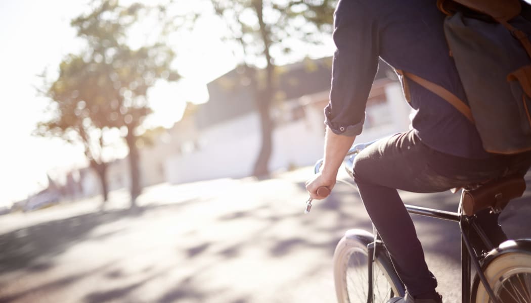 Man riding a bycicle near Crescent Oaks in Graham, North Carolina