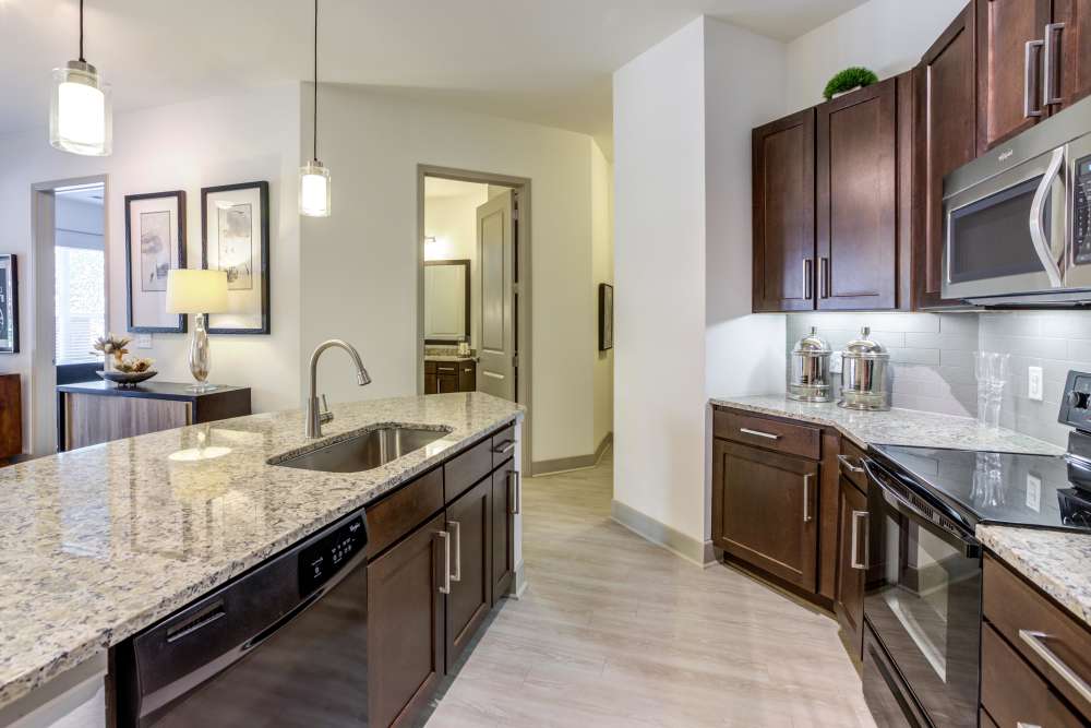 Kitchen with stainless-steel appliances and an island at Helios in Englewood, Colorado