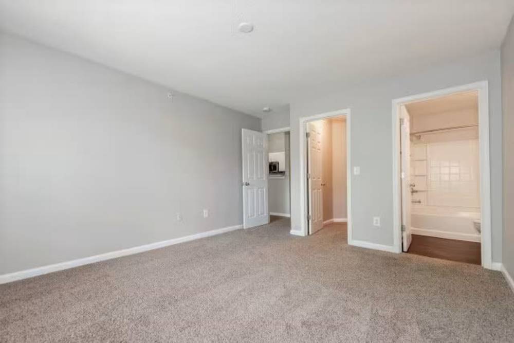 Spacious bedroom with walk in closets at Arbors at Fairview Apartments in Simpsonville, South Carolina