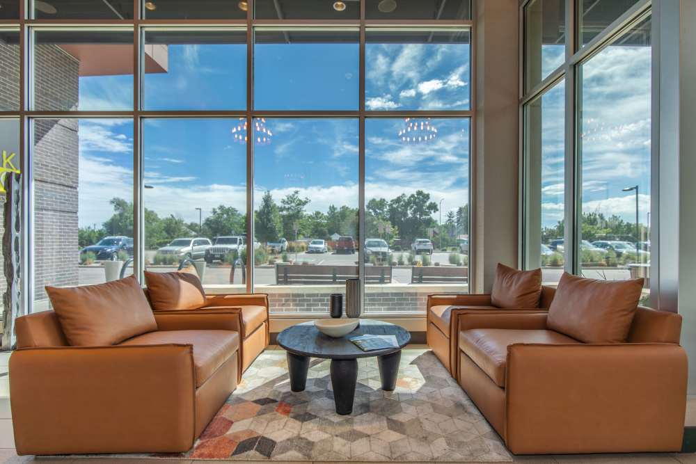 Community seating area with couch and large window at Park Place Olde Town Apartments in Arvada, Colorado