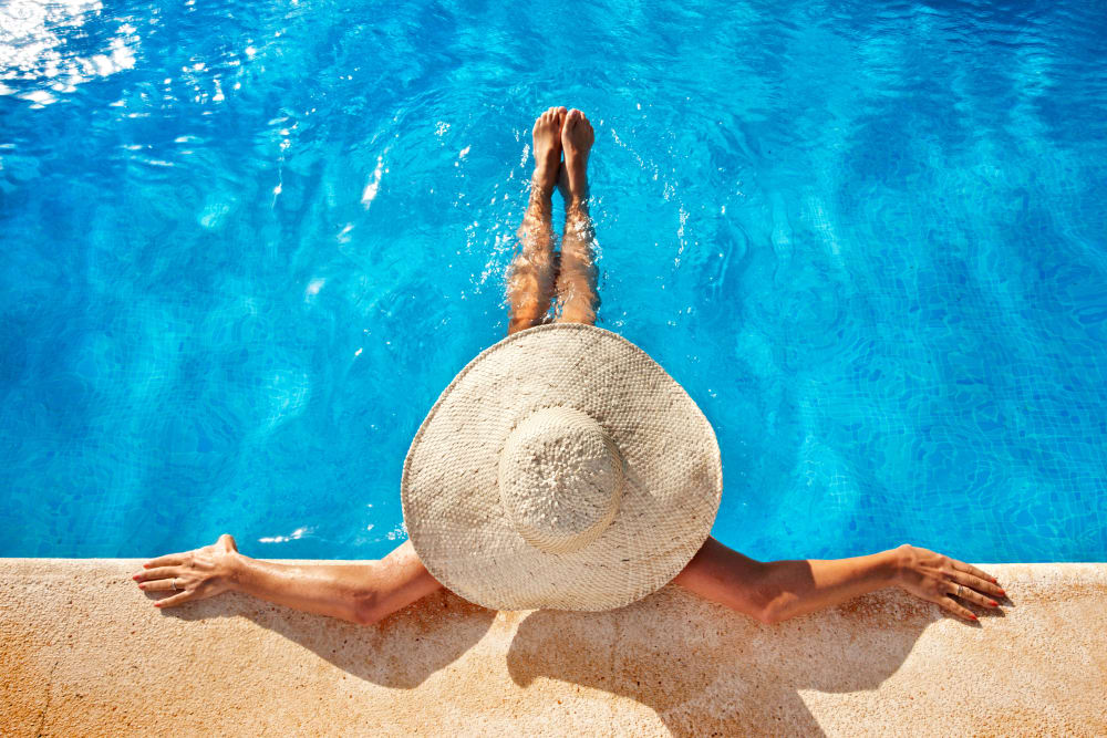 A woman enjoying the swimming pool at Avery Park Apartments in Fairfield, California