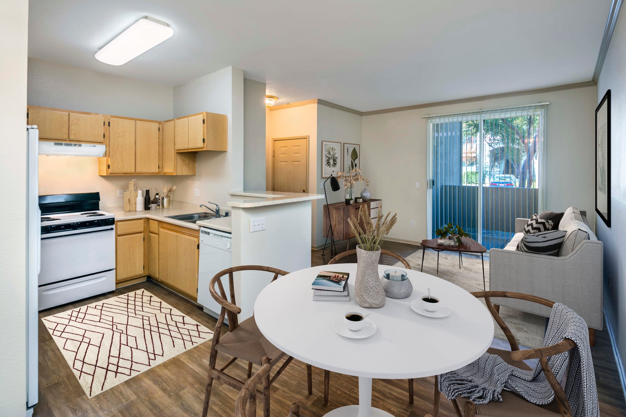 A dining room and kitchen at Natomas Park Apartments in Sacramento, California