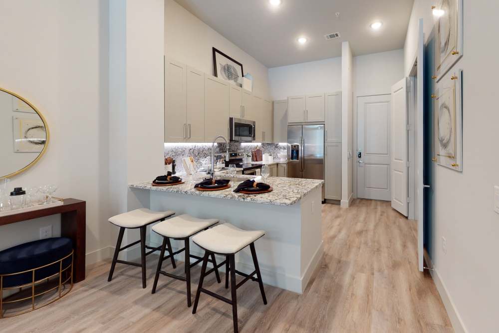 Kitchen with breakfast bar at Cornell Midtown in Dallas, Texas