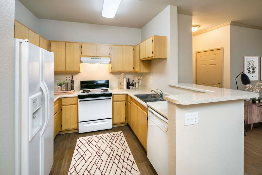 Kitchen with wood-style flooring at Natomas Park Apartments in Sacramento, California