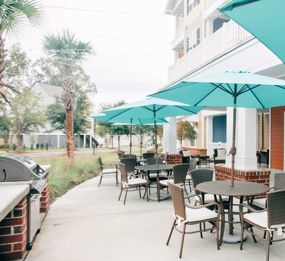 Exterior seating area with barbeque at Harmony at West Ashley in Charleston, South Carolina