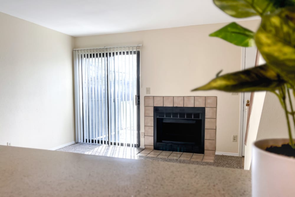 Living room with fireplace at Stonehaven Apartments in Hazelwood,Missouri