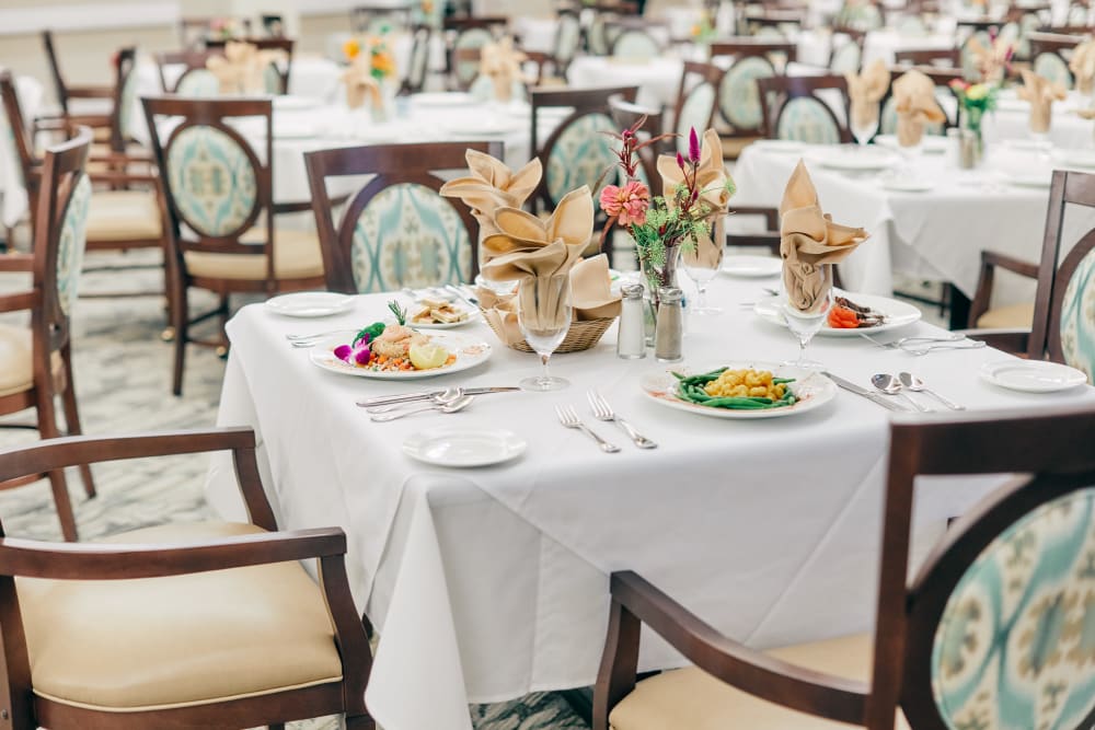 Well decorated dining room tables at Harmony at West Ashley in Charleston, South Carolina