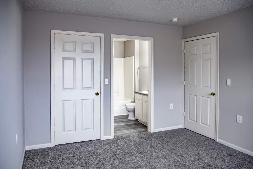 Apartment bedroom with attached bathroom at Whispering Plains Apartments in Guymon, Oklahoma