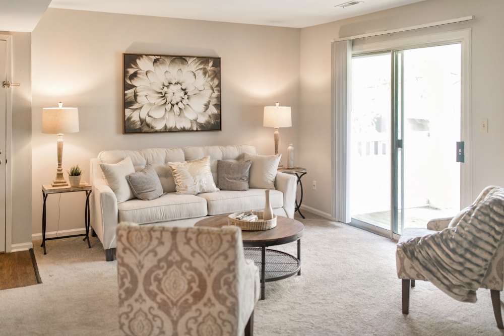 Living room with access to balcony at Bonhomme Village in Olivette. MO