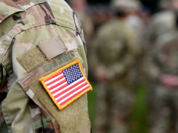 Military resident honoring a fallen comrade with his squad near EVIVA Midtown in Sacramento, California