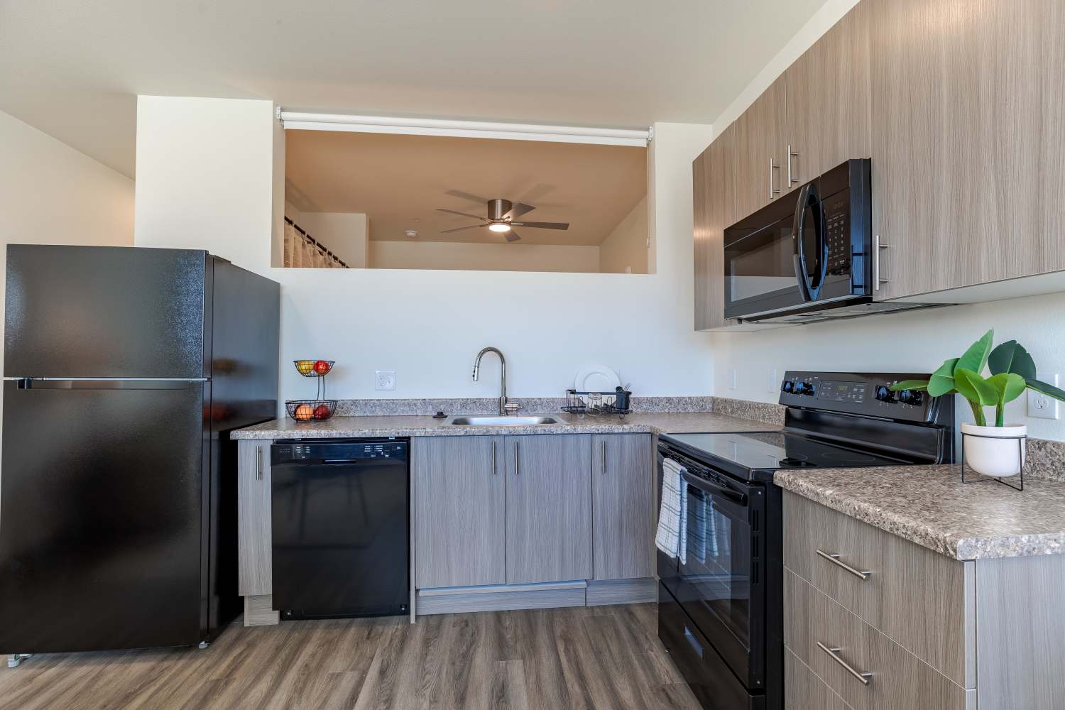 Kitchen with black appliances at Sable Station in Aurora, Colorado