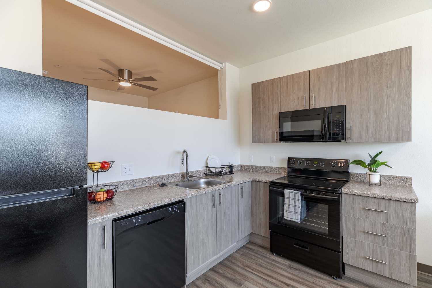 Kitchen with black appliances at Sable Station in Aurora, Colorado