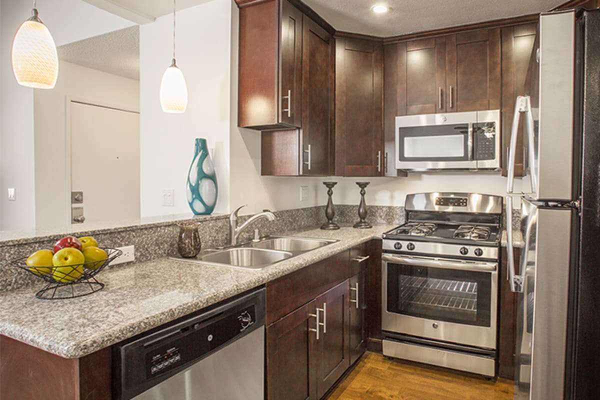 Kitchen with stainless-steel appliances at Volta on Broadway, Tempe, Arizona