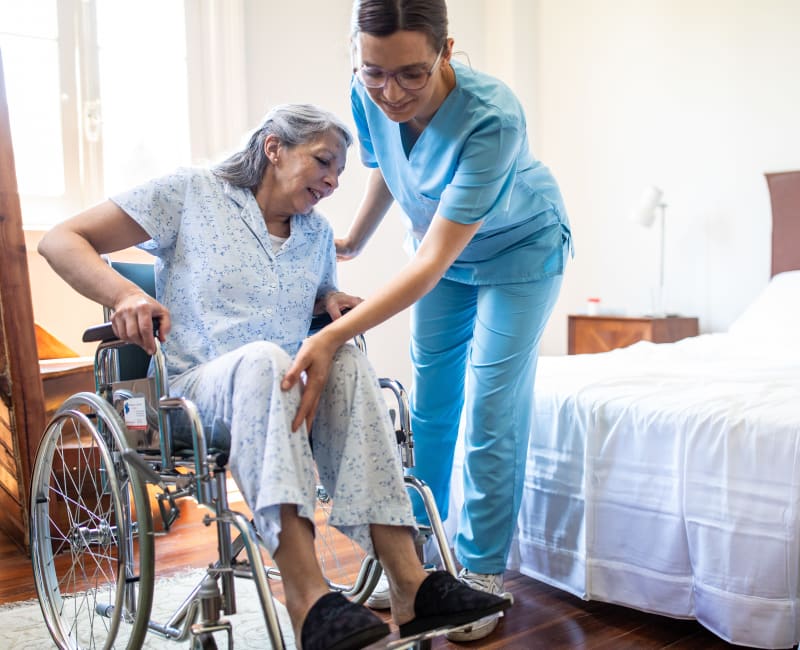 A caregiver helping a resident at The Sanctuary at West St. Paul in West St. Paul, Minnesota