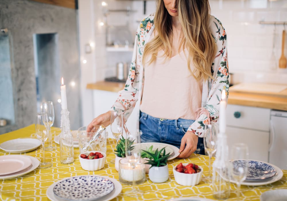 Resident preparing a fresh and delicious meal in her gourmet kitchen at Sofi Berryessa in San Jose, California