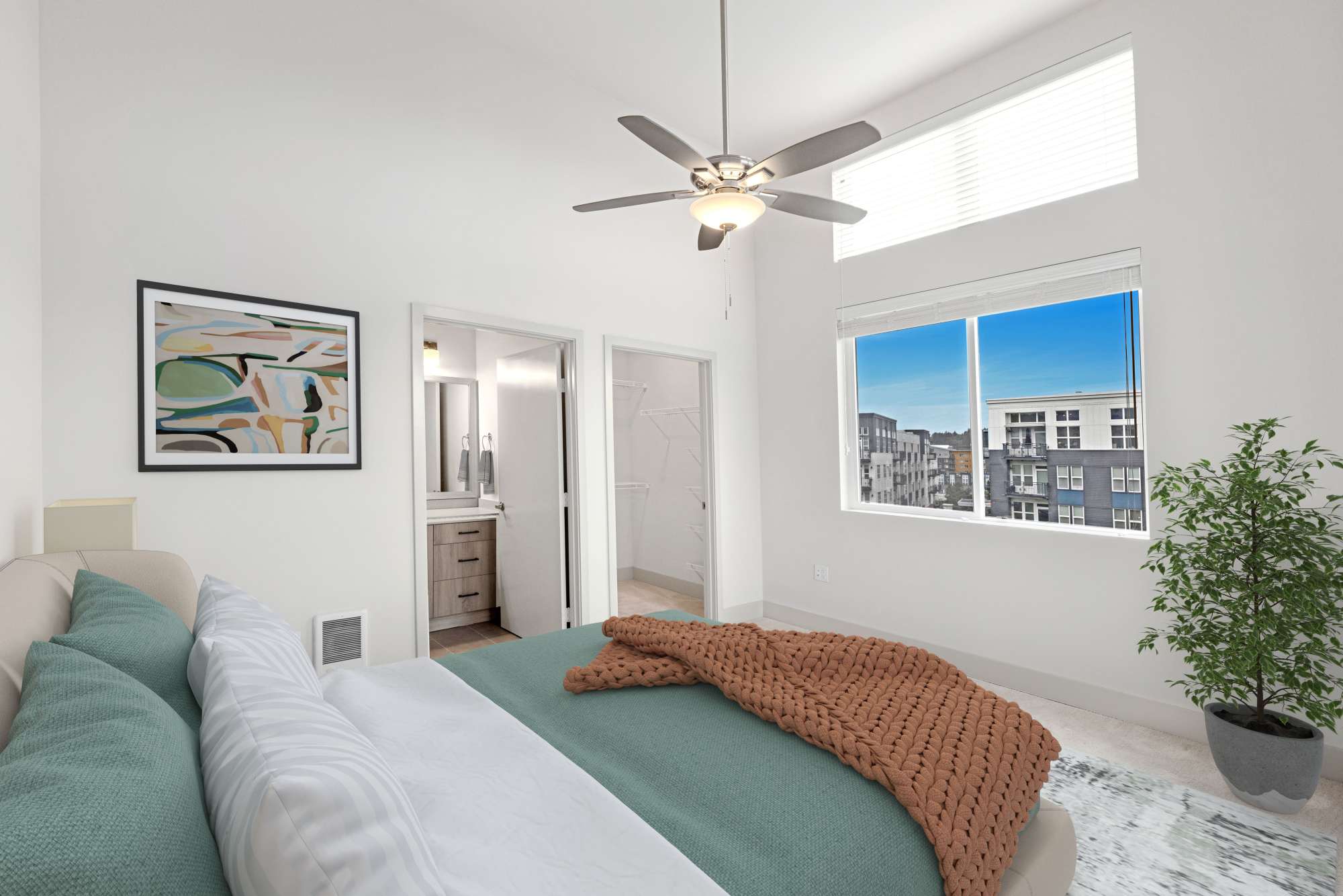 Bedroom with window and attached bathroom at Radiate in Redmond, Washington