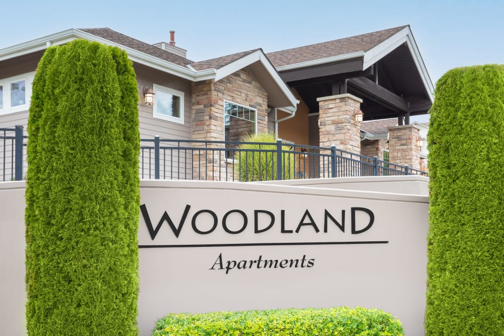 Signage highlighting community entrance at Woodland Apartments in Olympia, Washington