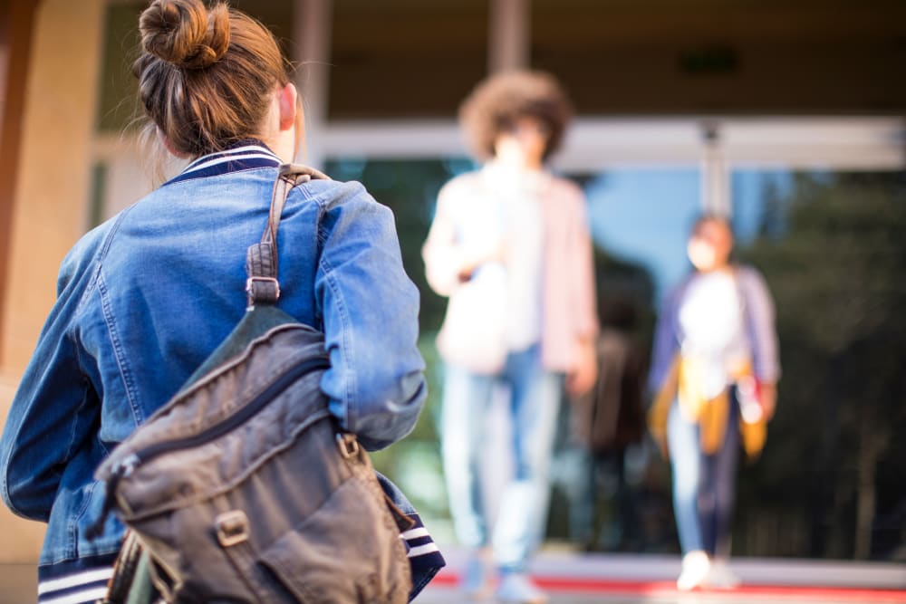 Student walking to their school near Sausalito Apartments in College Station, Texas