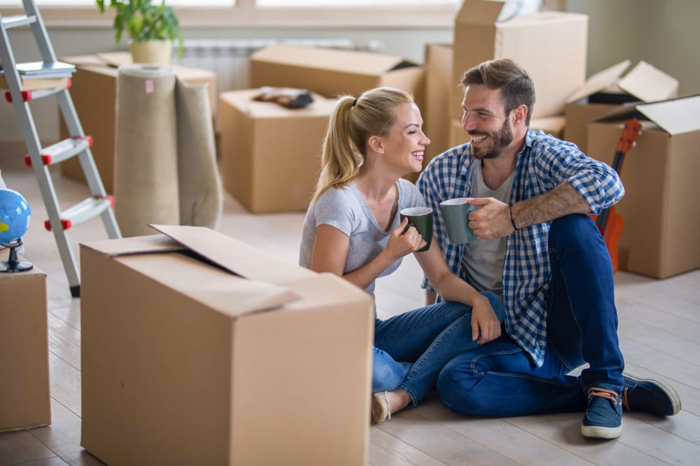 A couple takes a coffee break while packing their belongings near Box Self Storage in Junction City, Kansas