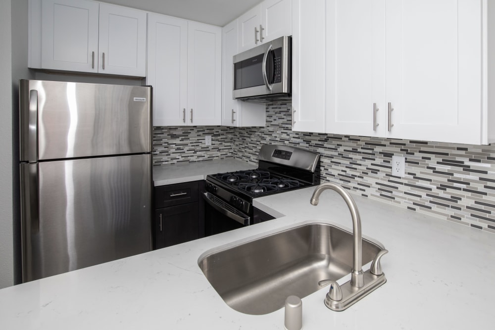 Model kitchen with stainless-steel appliances at Club Marina Apartments in Los Angeles, California