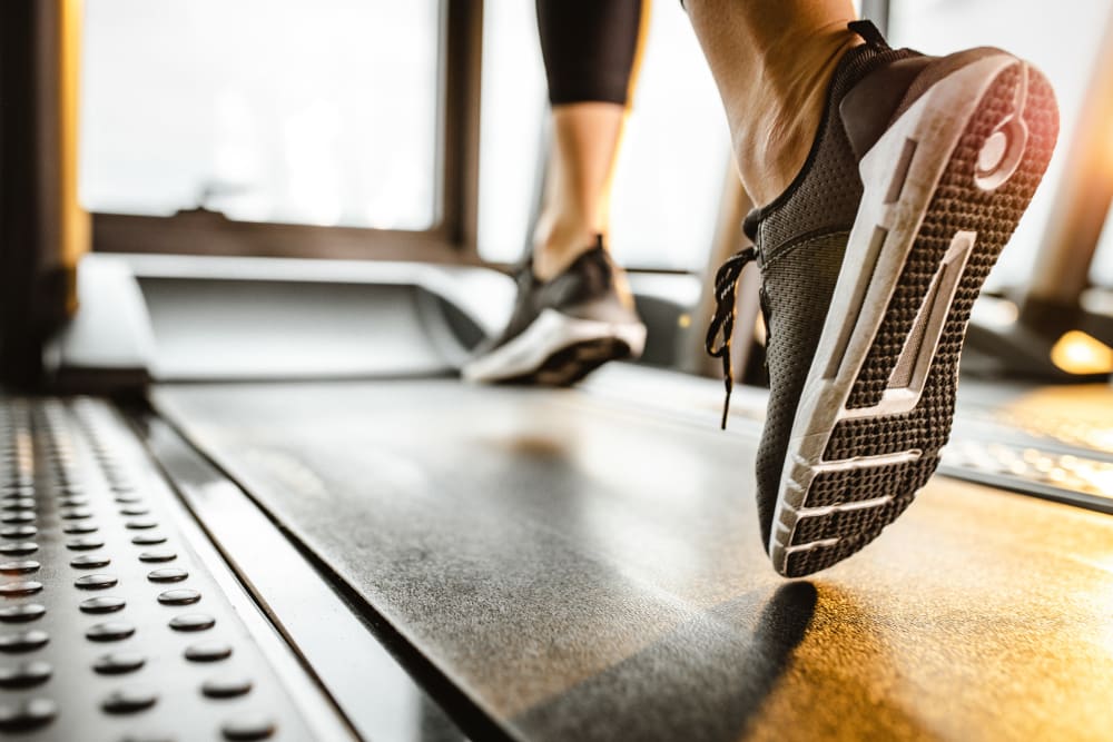 A woman jogging in the fitness center at Newport Crossing Apartments in Newcastle, Washington